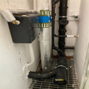 A cleaning access point at the bottom of a new Geberit HDPE soil stack A cleaning access point at the bottom of a new Geberit HDPE soil stack