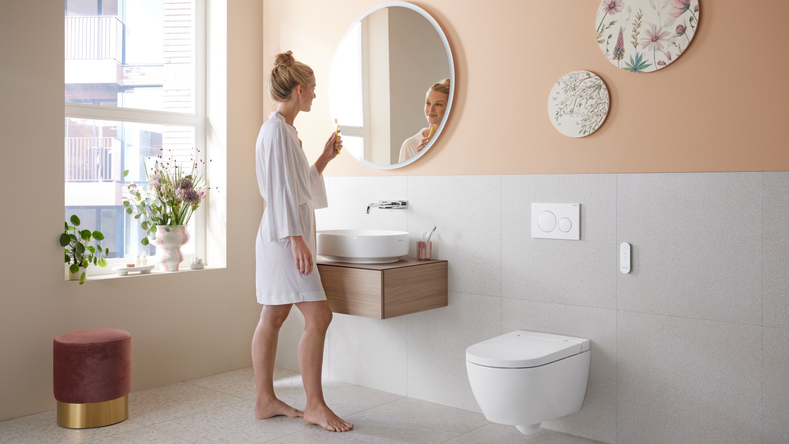 Woman in bathroom with Geberit AquaClean Alba – a cost-effective bidet toilet with spray functionality