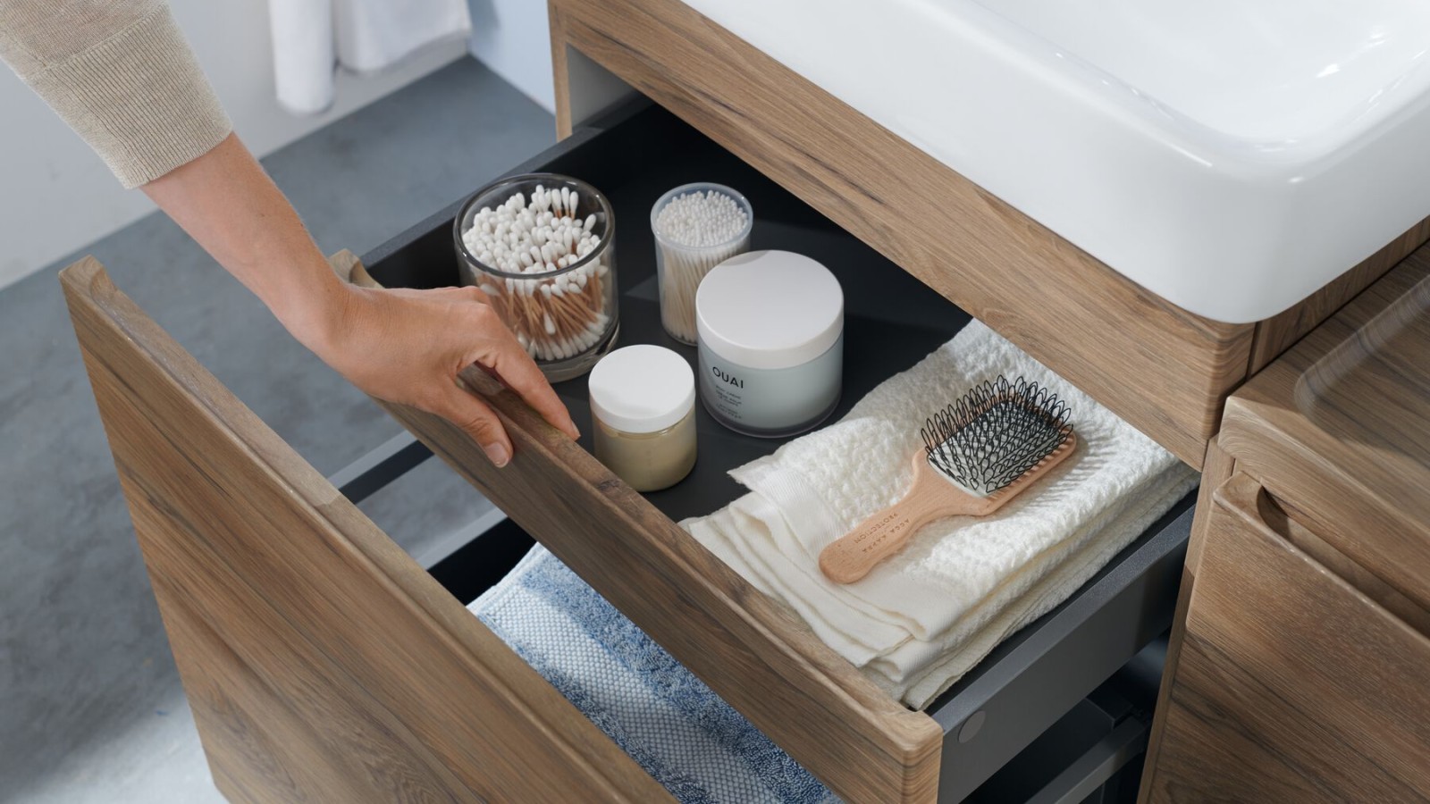 Woman opens Geberit Renova Plan vanity unit Woman opens Geberit Renova Plan vanity unit