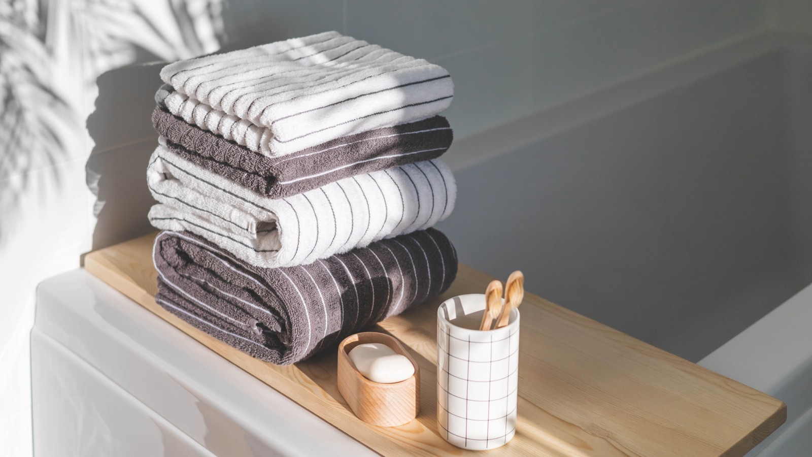 Striped towels in a white bathroom (© iStock)