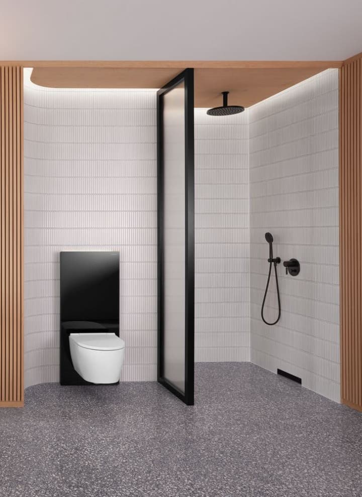 A bathroom with a wooden wall and a shower and WC area in black and white A bathroom with a wooden wall and a shower and WC area in black and white