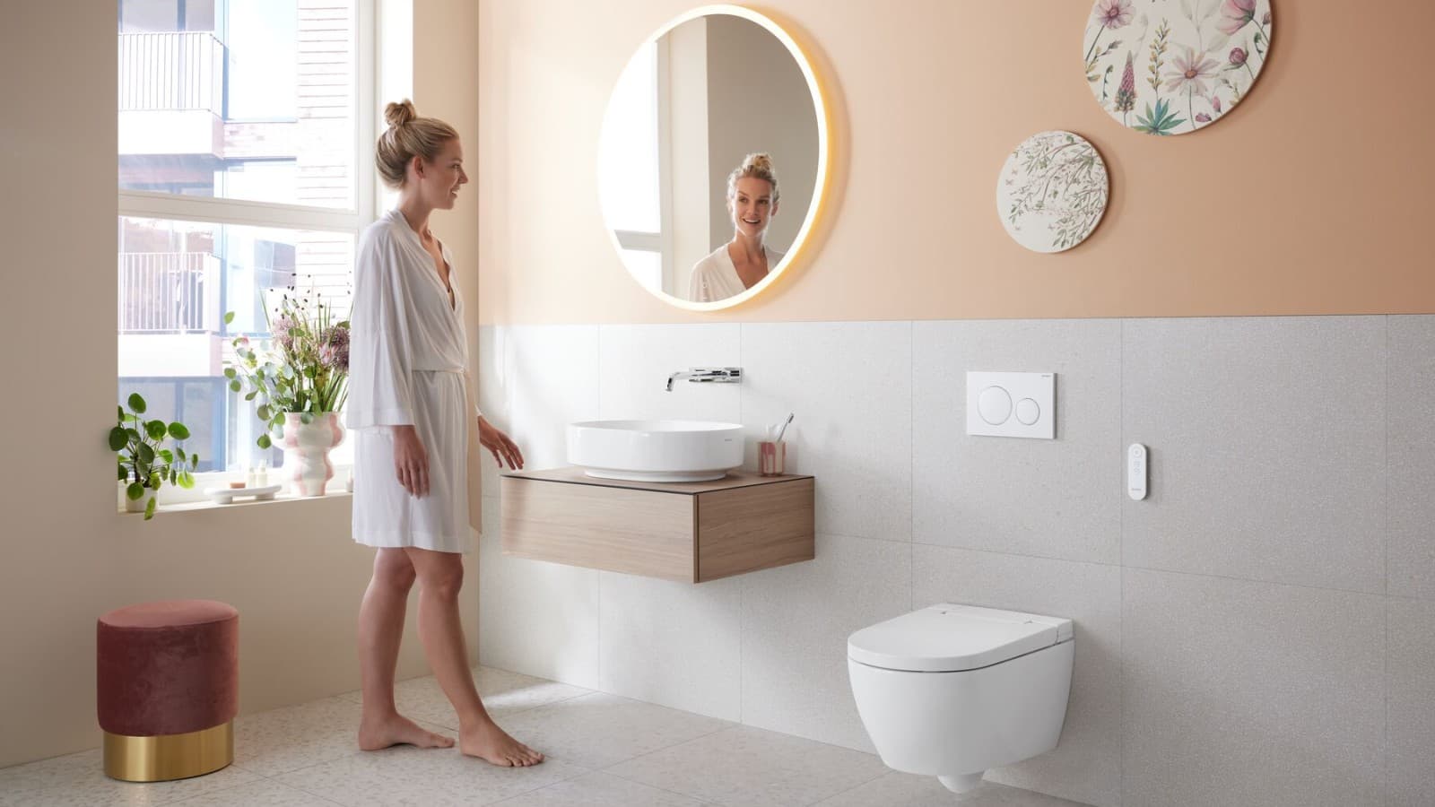 Woman in bathroom with a floating toilet Woman in bathroom with a floating toilet